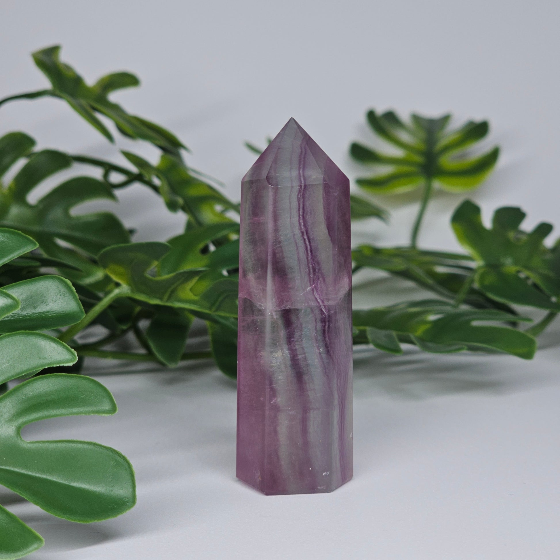 Fluorite tower with mixed colour banding in purple and green with smooth polished surface