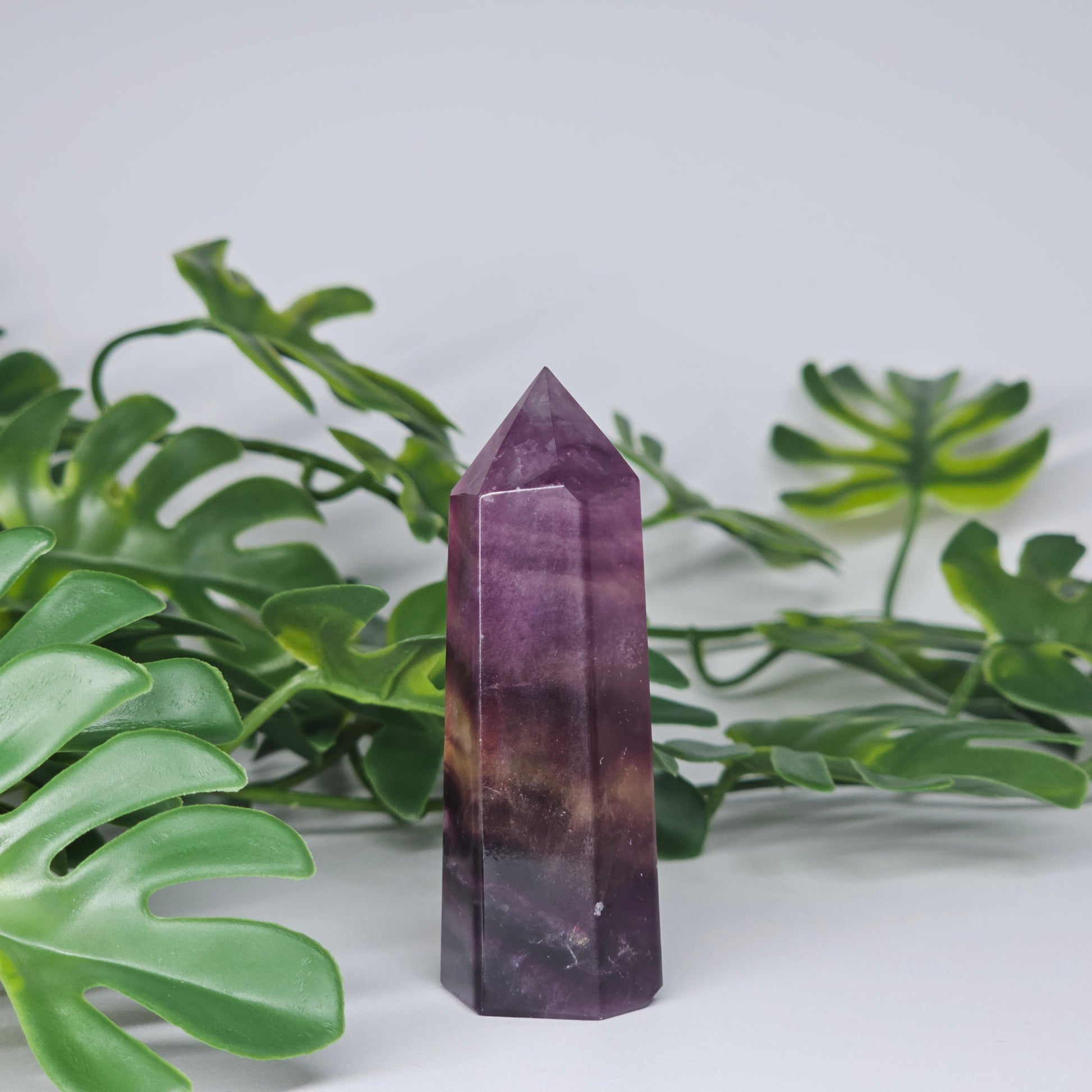 Fluorite tower with mixed colour banding in purple and yellow with smooth polished surface