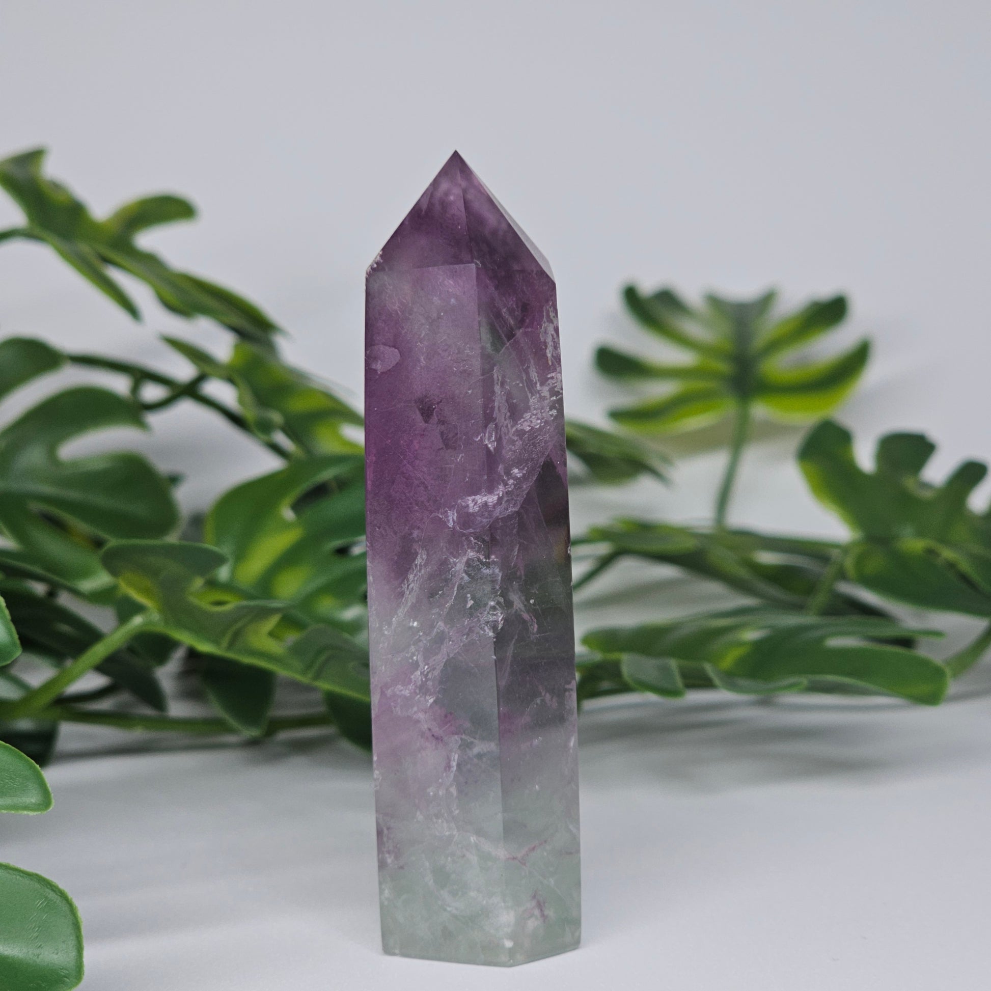 Fluorite tower with mixed colour banding in purple and green with smooth polished surface