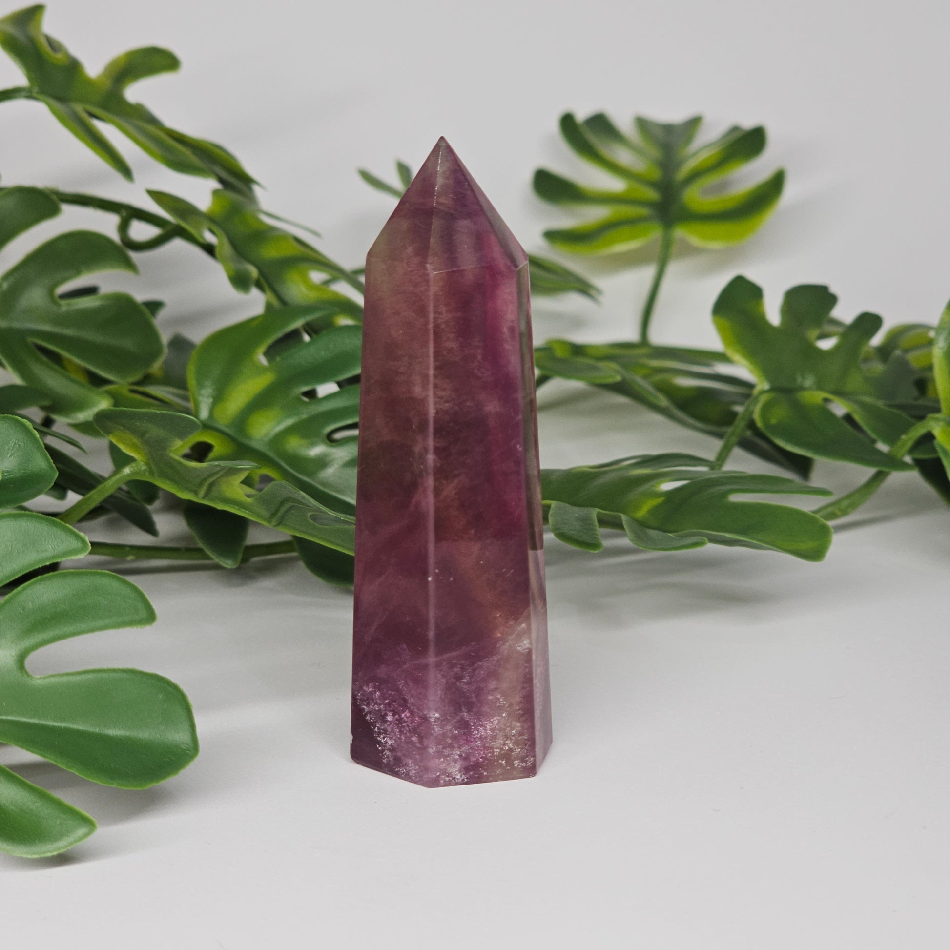 Fluorite tower with mixed colour banding in purple and yellow with smooth polished surface