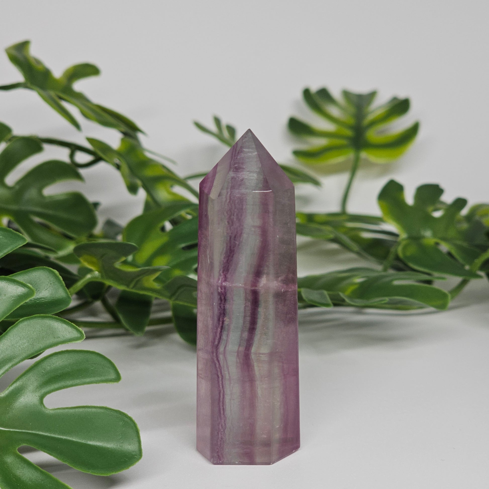 Fluorite tower with soft purple and green tones showing natural banding and polished finish