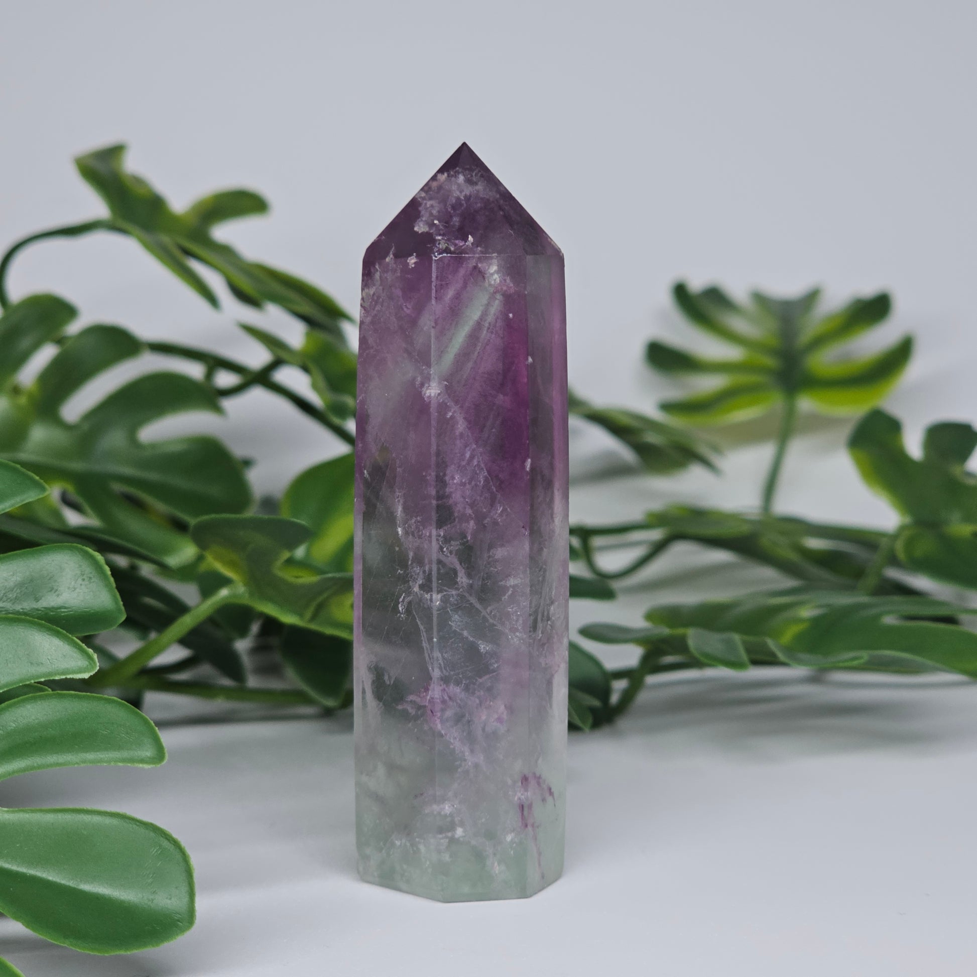 Fluorite tower with soft purple and green tones showing natural banding and polished finish