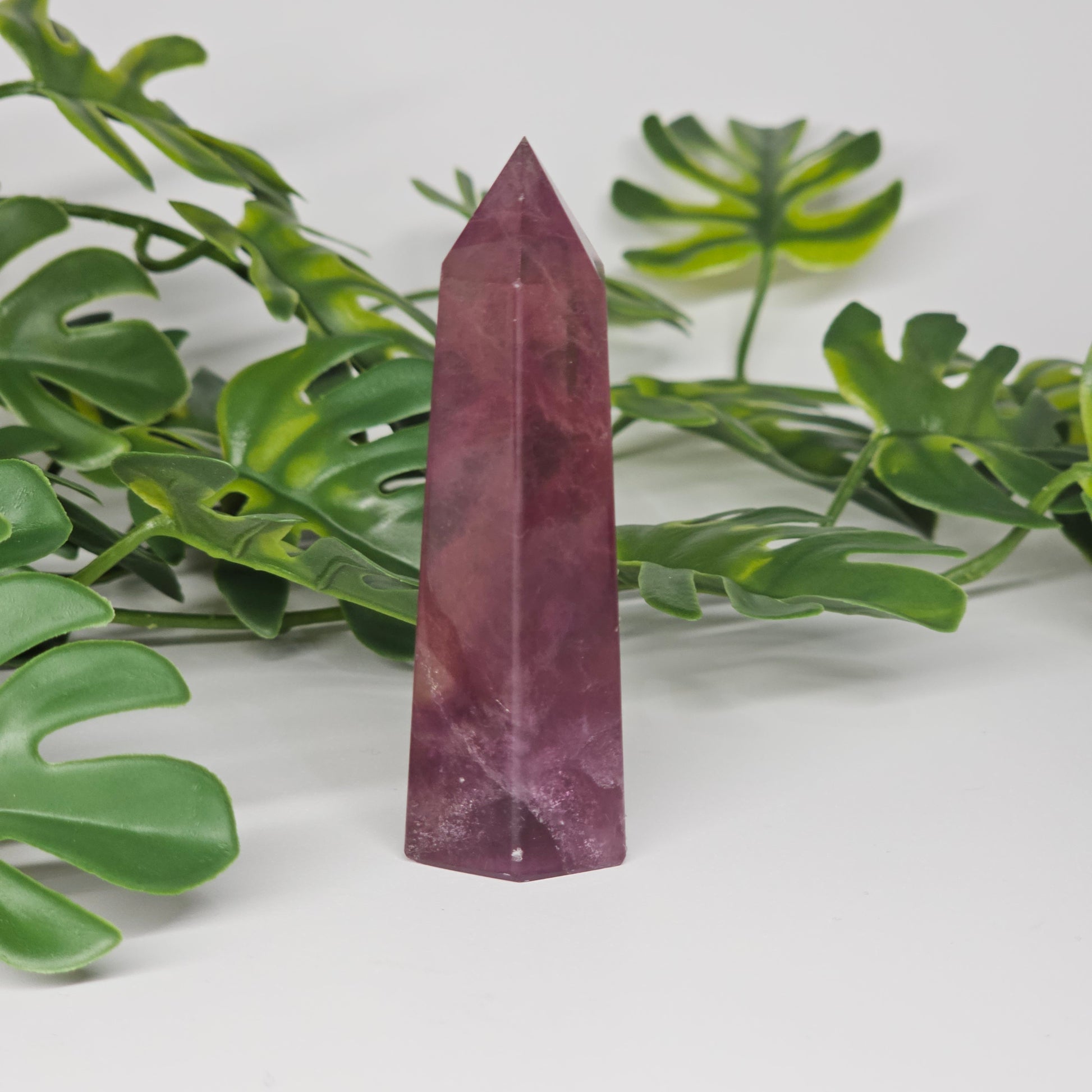 Fluorite crystal tower side view displaying layered colour zones and translucent natural formation