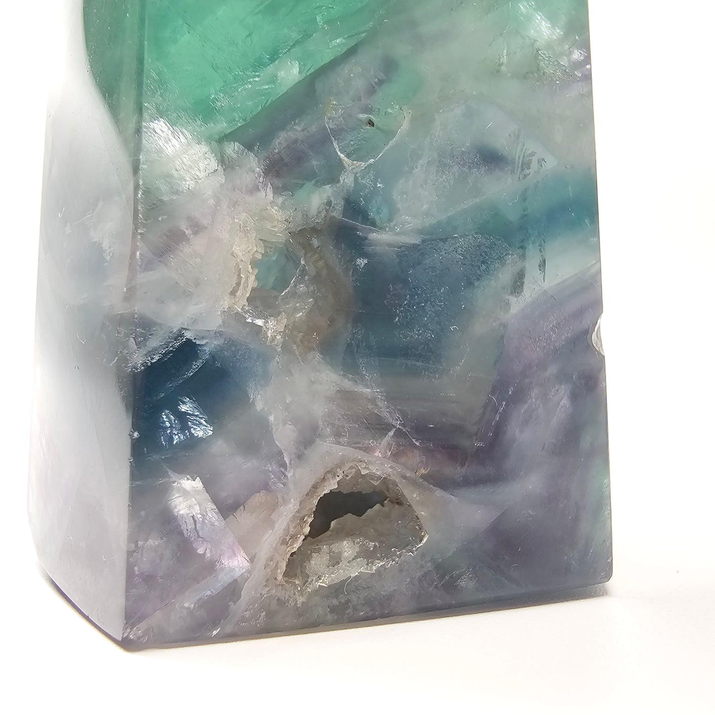 Close up detail of fluorite tower crystal showing natural banded patterns and druzy cave