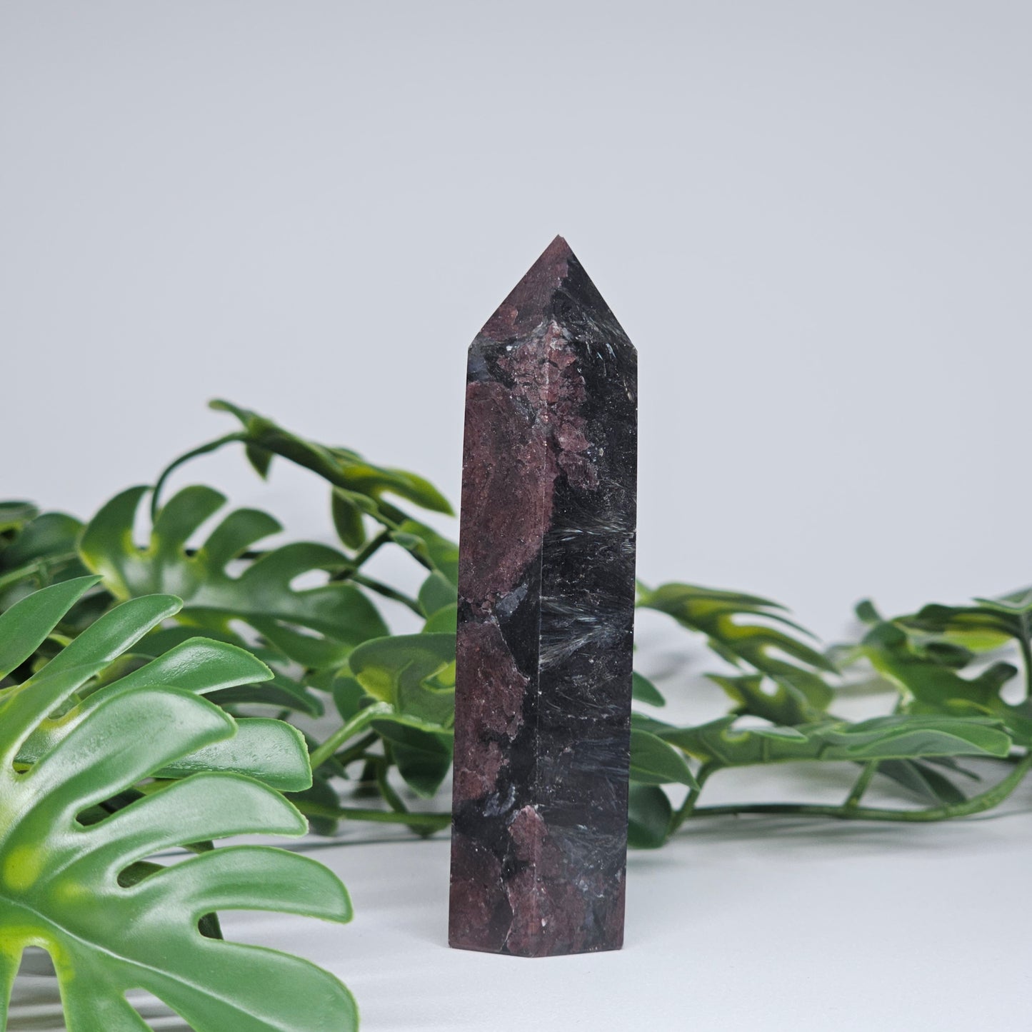 Garnet and Arfvedsonite crystal tower with deep red and black natural mineral formation