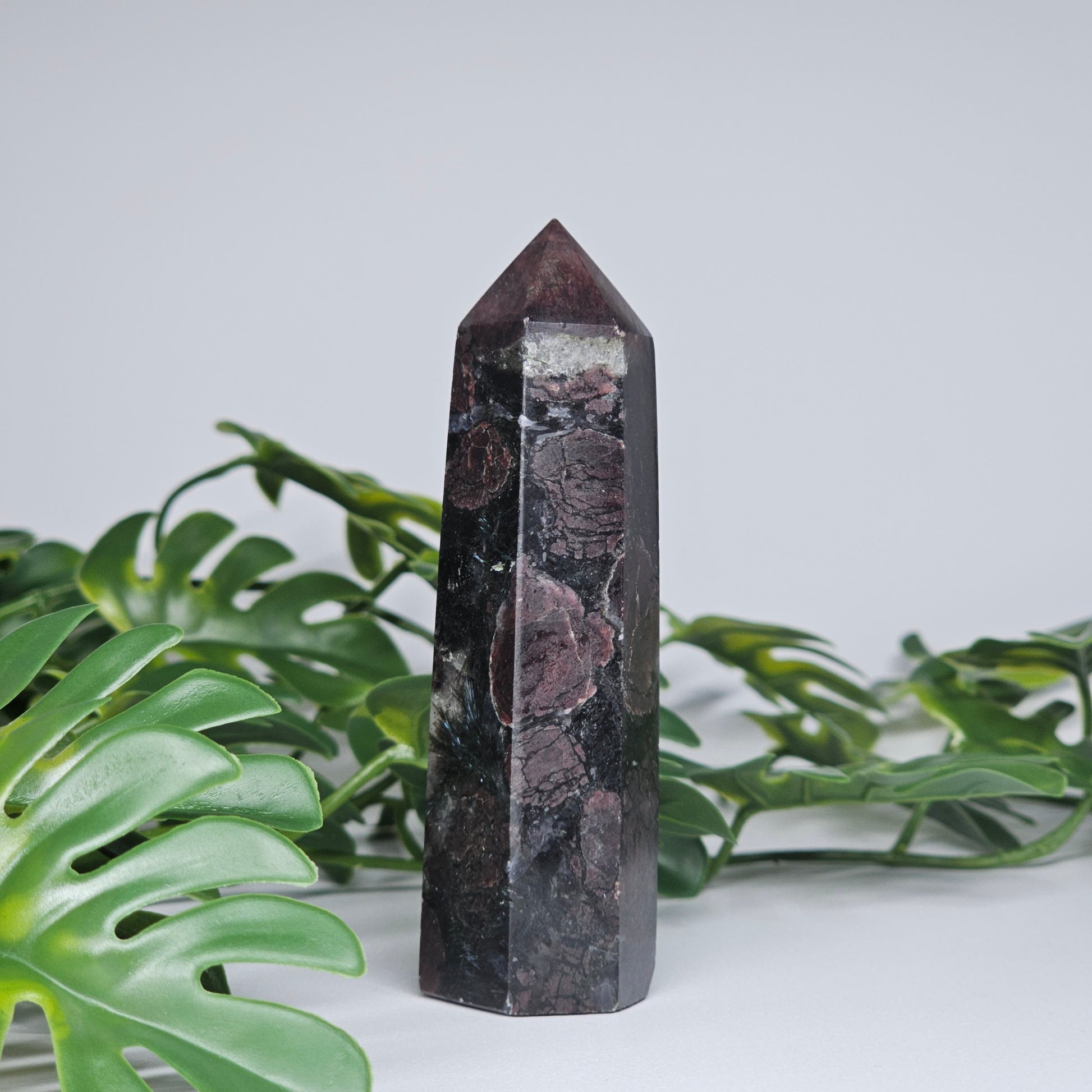 Garnet and Arfvedsonite crystal tower with deep red and black natural mineral formation