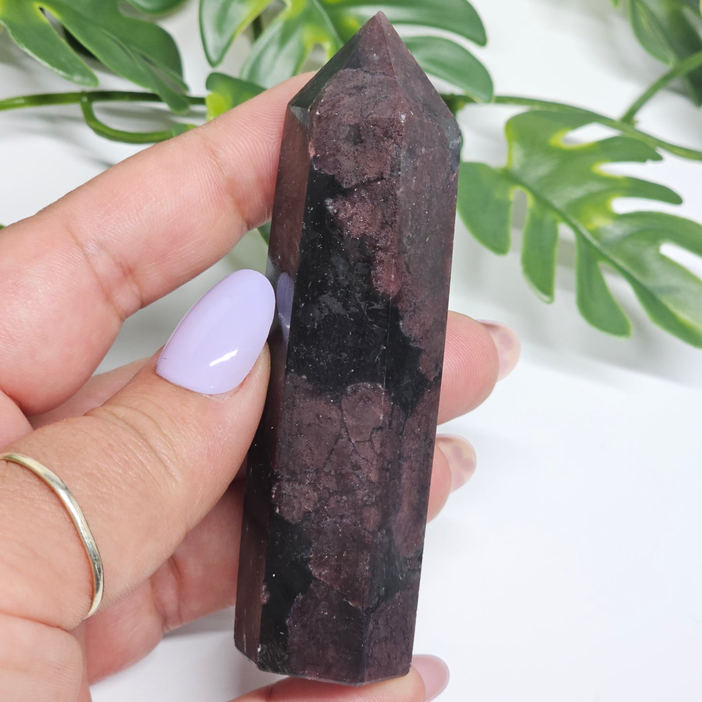 Garnet and Arfvedsonite crystal tower held in hand showing size and natural formation