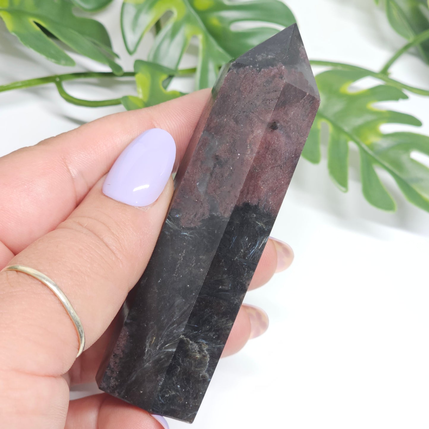 Garnet and Arfvedsonite crystal tower held in hand showing size and natural formation