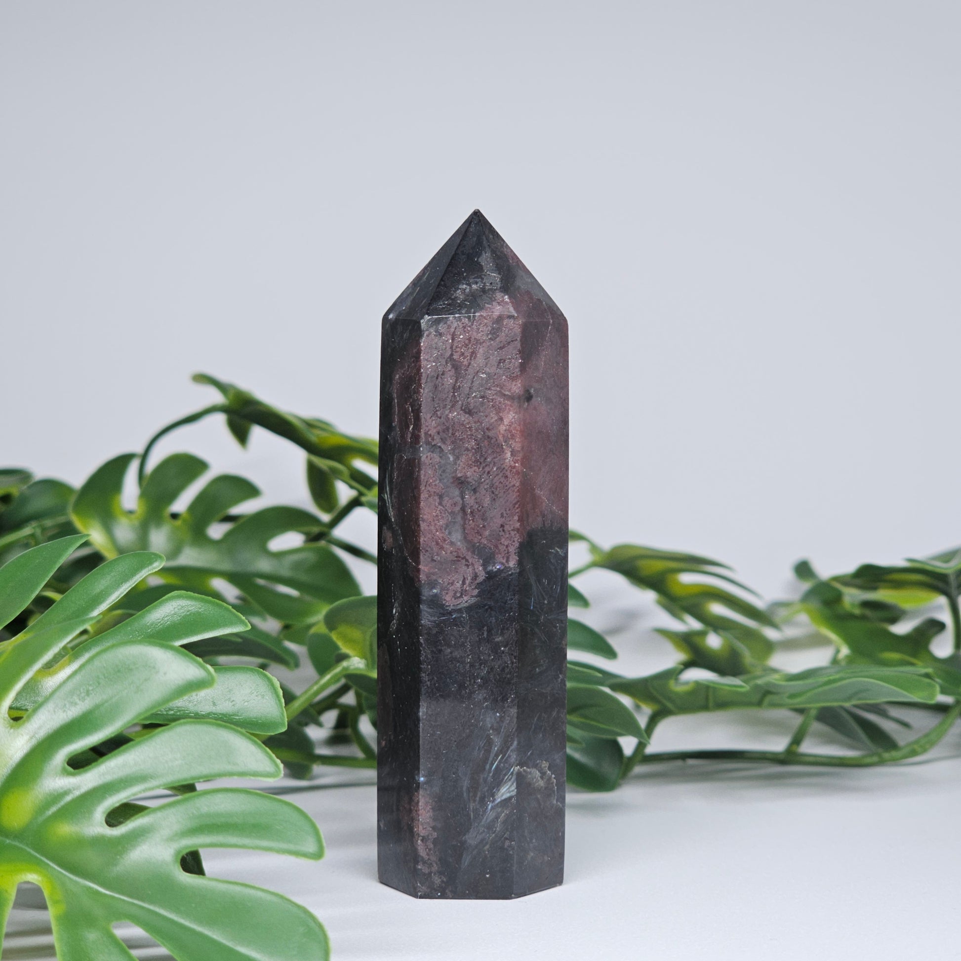 Garnet and arfvedsonite healing crystal tower with polished point and earthy tones
