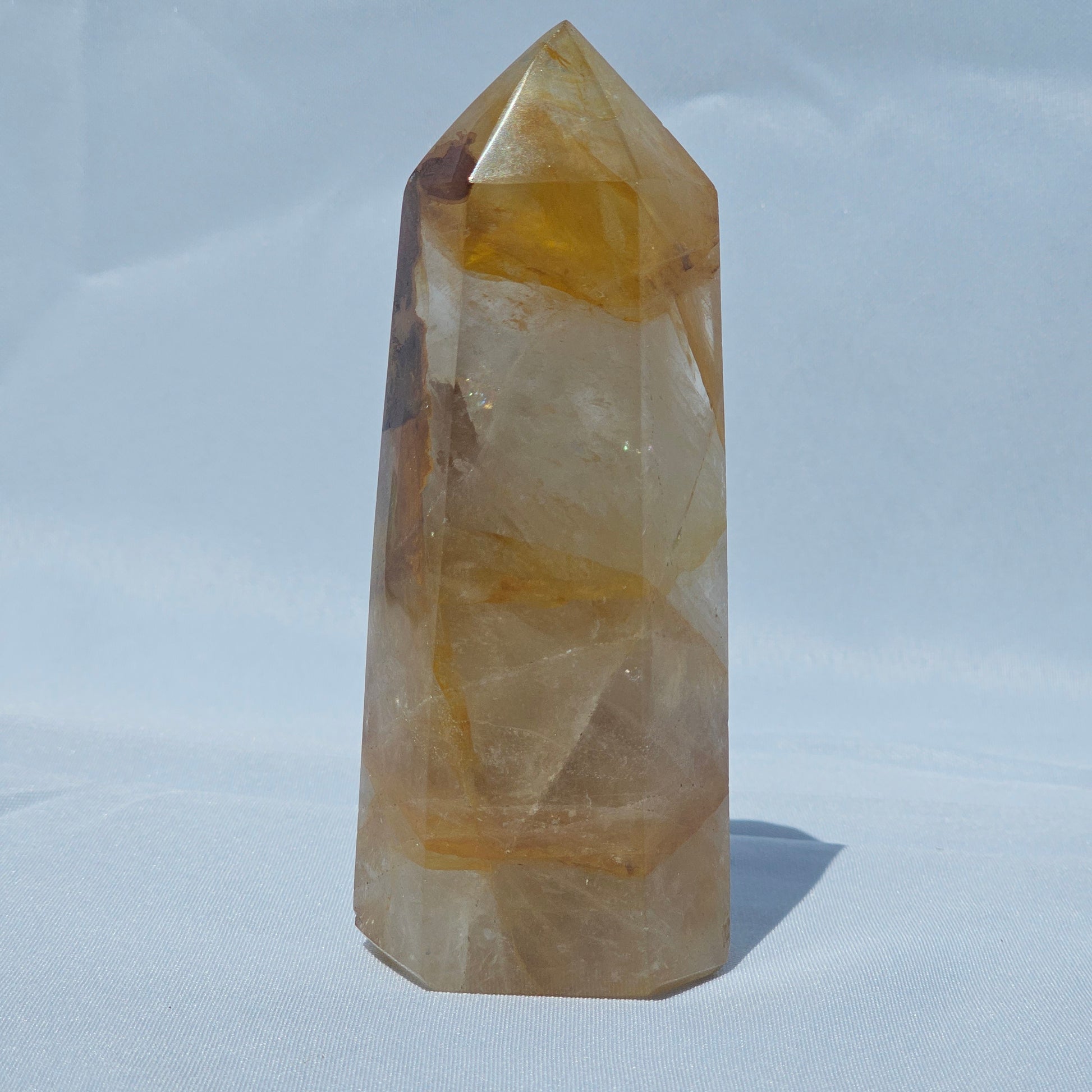 Golden Healer tower showing shimmer and rainbows in sunlight.