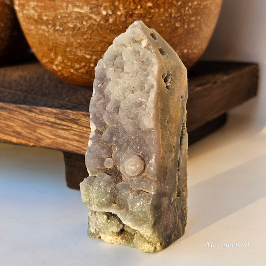 Angled view of Grape Agate obelisk showing both front face and side profile with natural colour variation and organic texture.