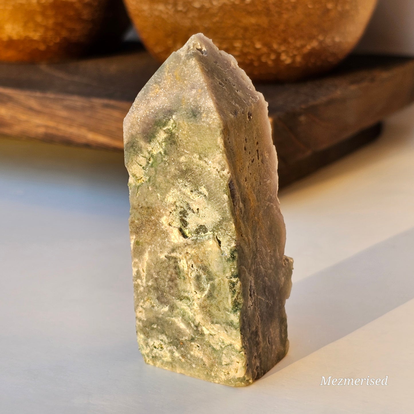 Back view of Grape Agate obelisk showing exposed matrix base and natural crystal formation.