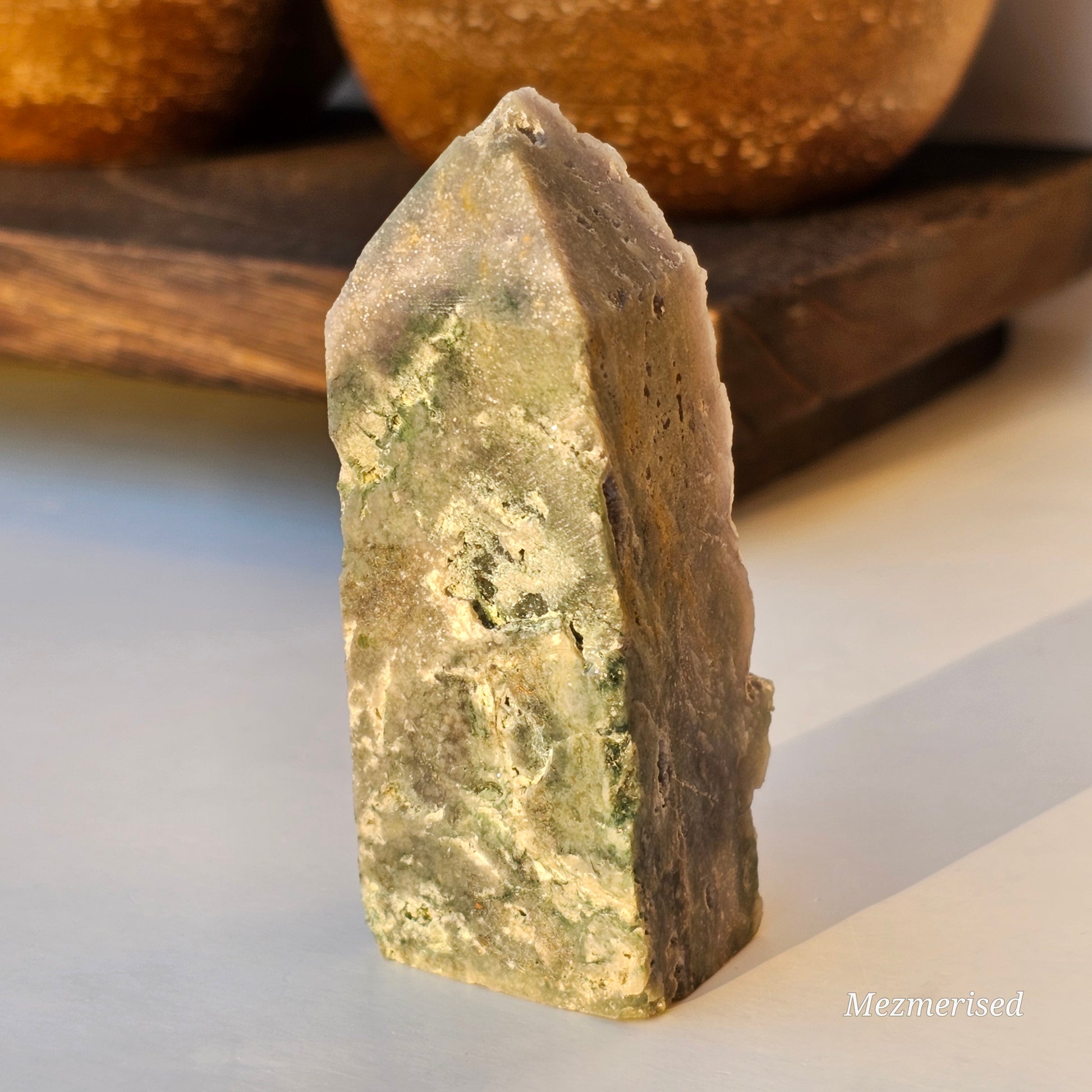 Back view of Grape Agate obelisk showing exposed matrix base and natural crystal formation.