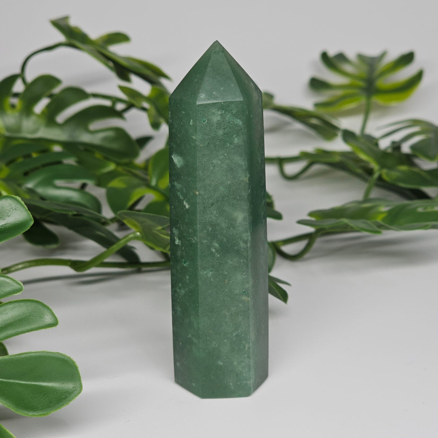 Green aventurine crystal tower for luck and prosperity displayed as home decor