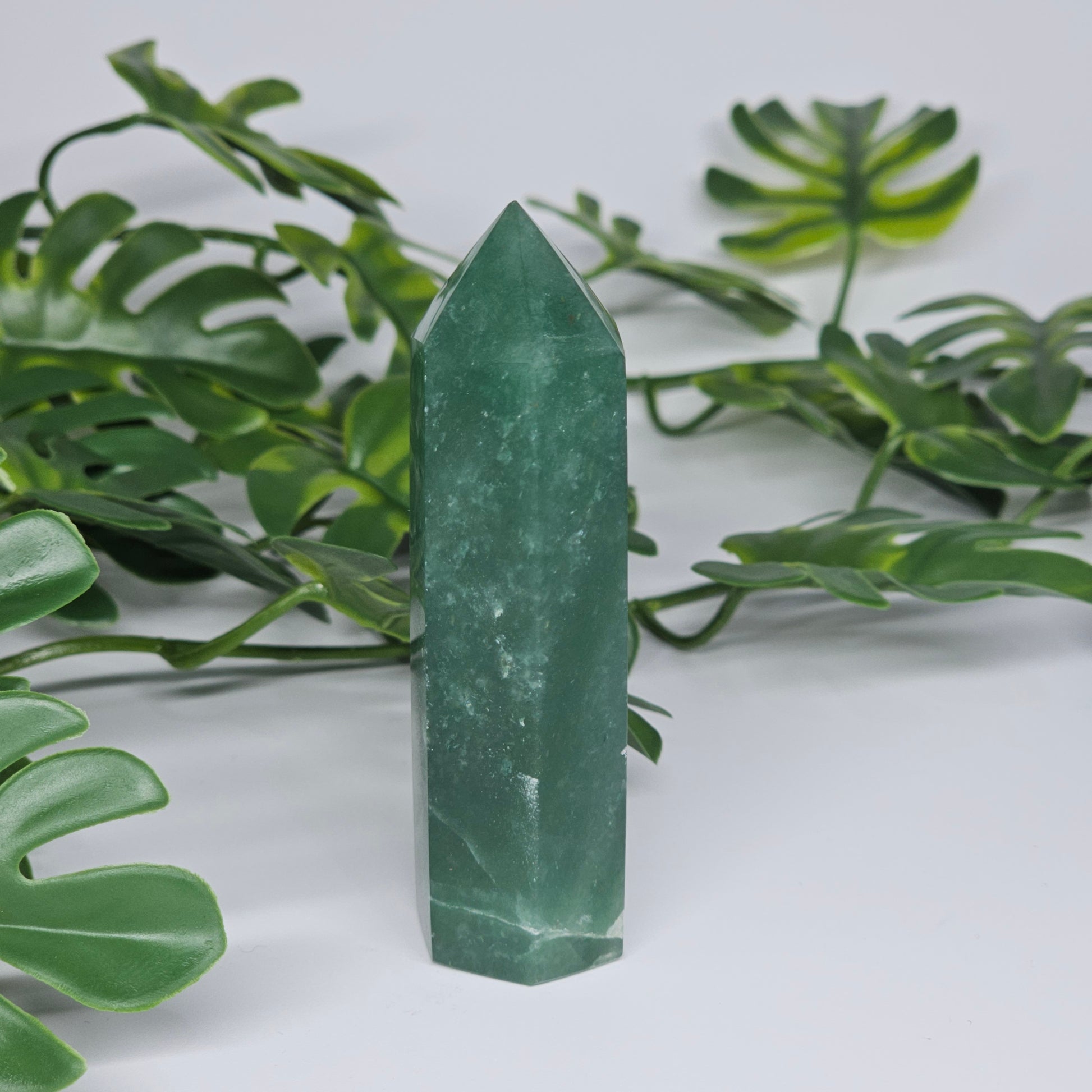 Green aventurine crystal tower for luck and prosperity displayed as home decor