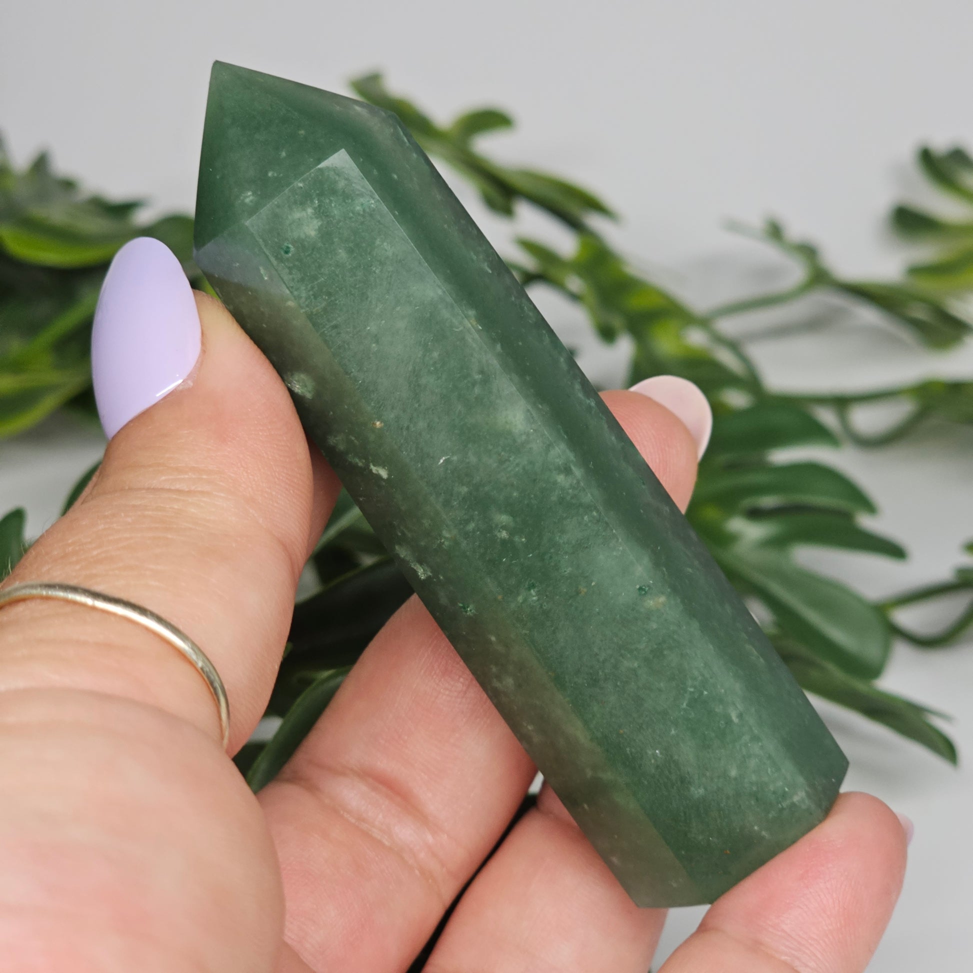 Close up of green aventurine crystal with subtle shimmer and natural texture