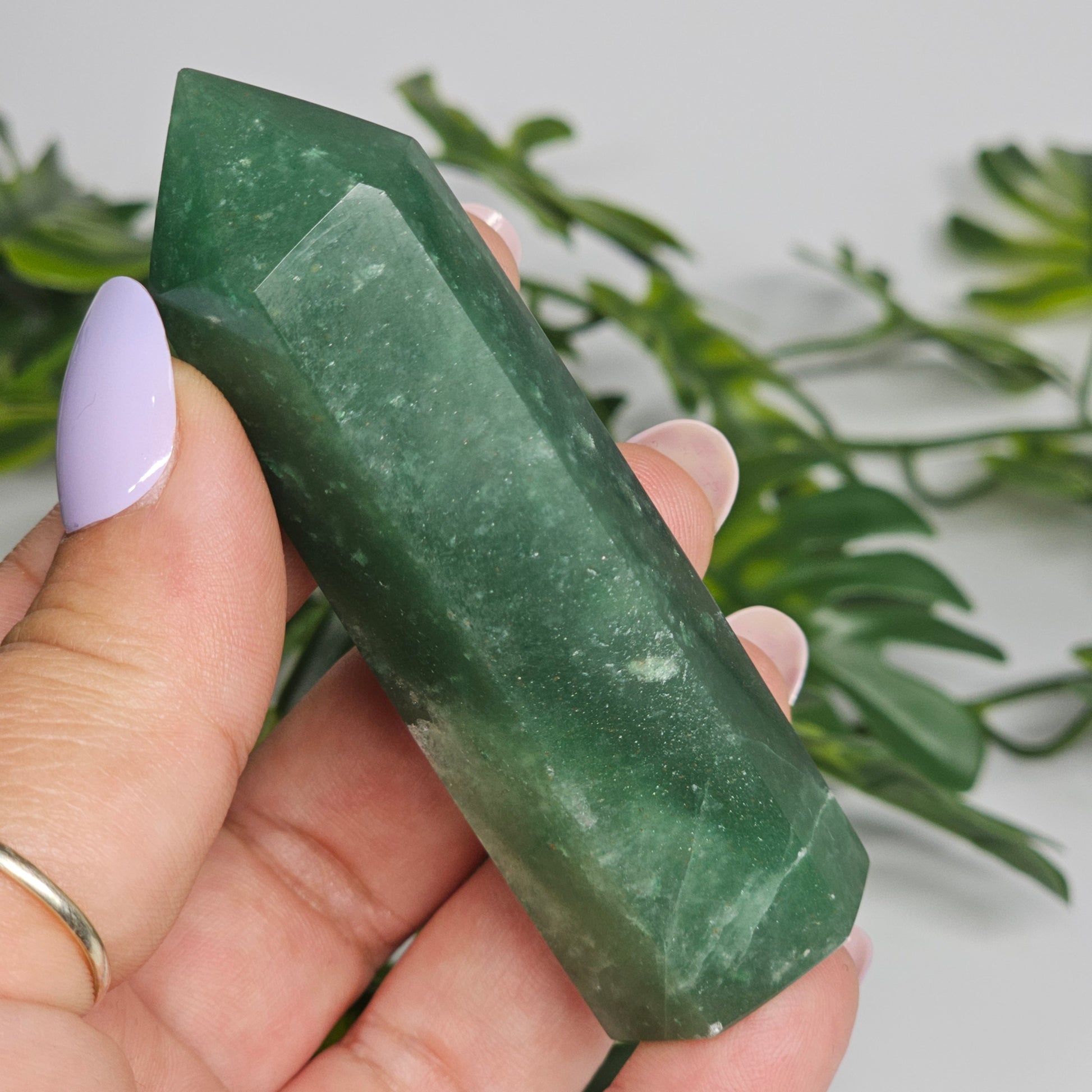Close up of green aventurine crystal with subtle shimmer and natural texture