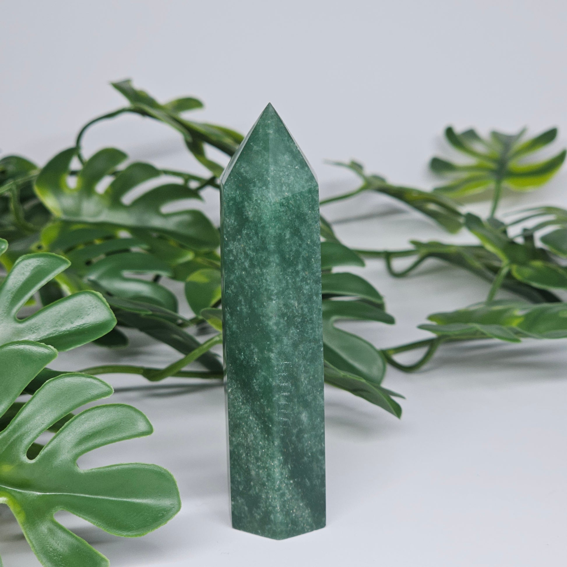 Green aventurine tower crystal showing smooth polished finish and natural tones