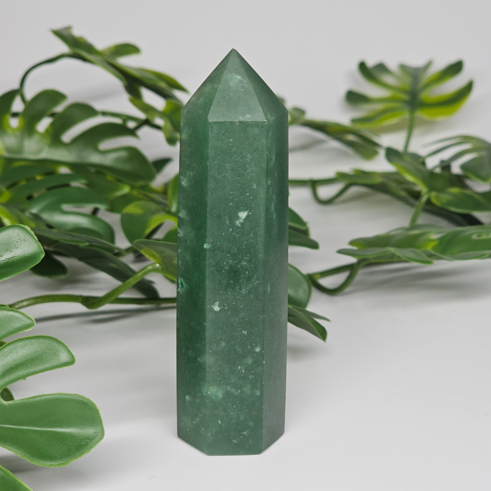 Green aventurine tower crystal showing smooth polished finish and natural tones