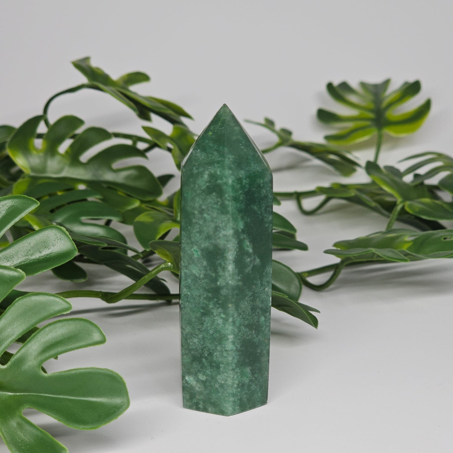 Green aventurine tower crystal showing smooth polished finish and natural tones