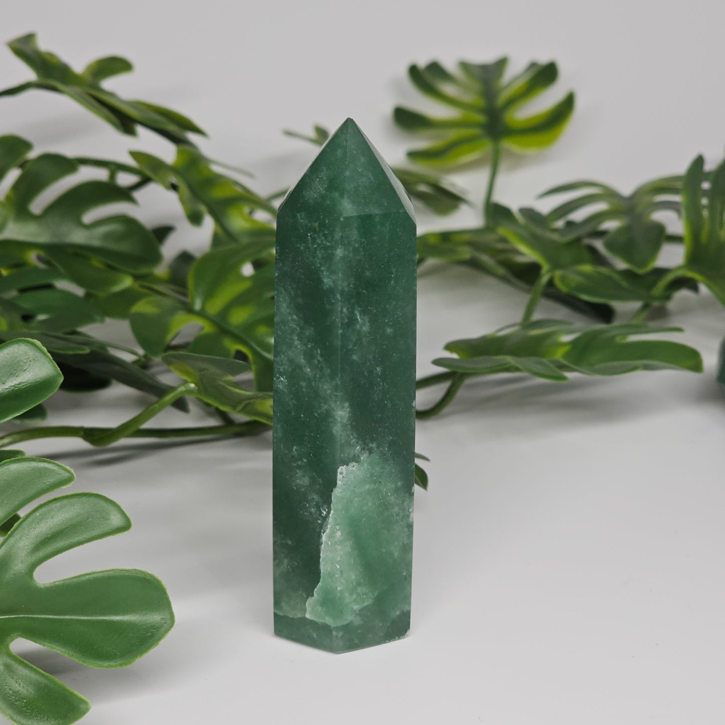 Green aventurine tower crystal showing smooth polished finish and natural tones