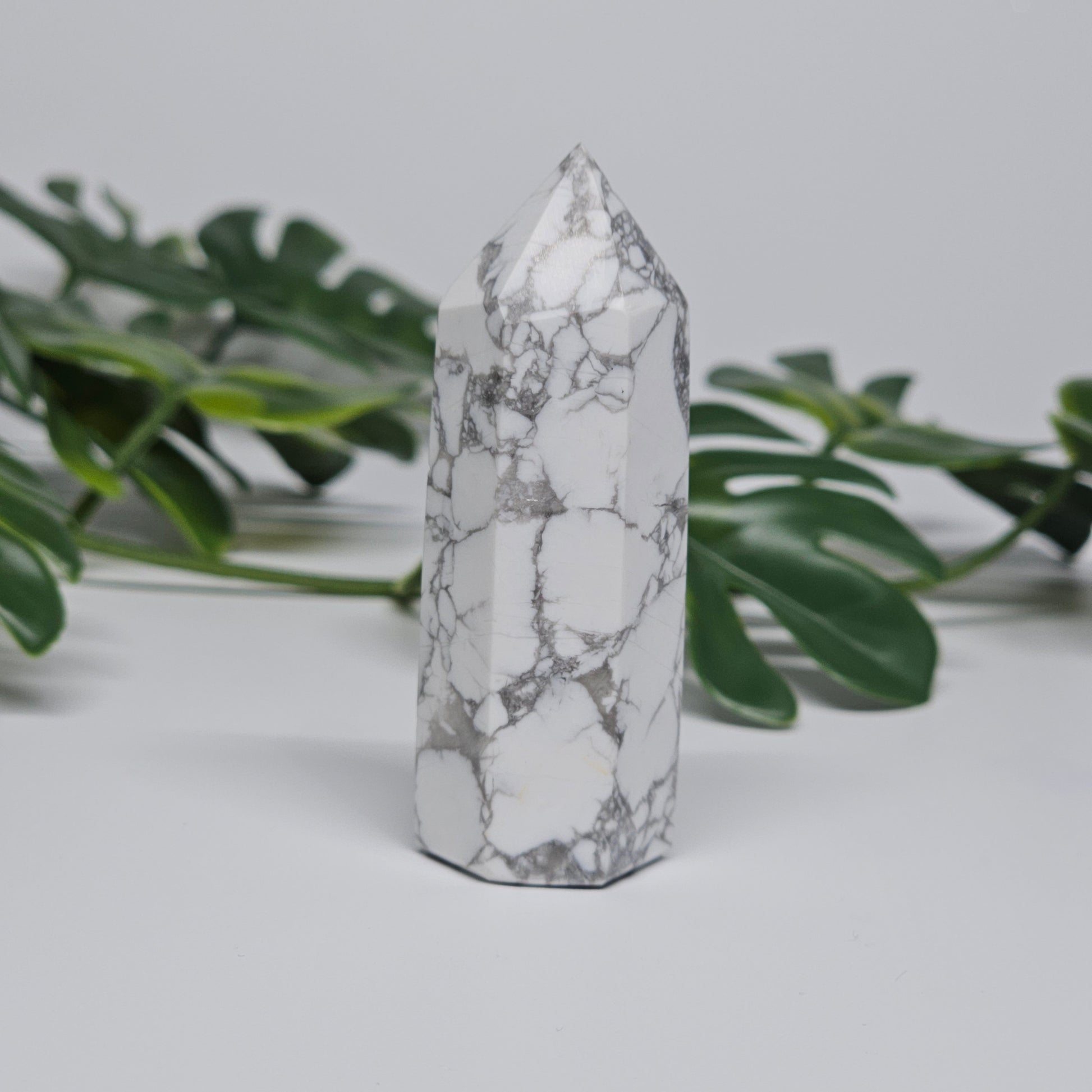 Side view of Howlite tower showing white stone and grey veining.