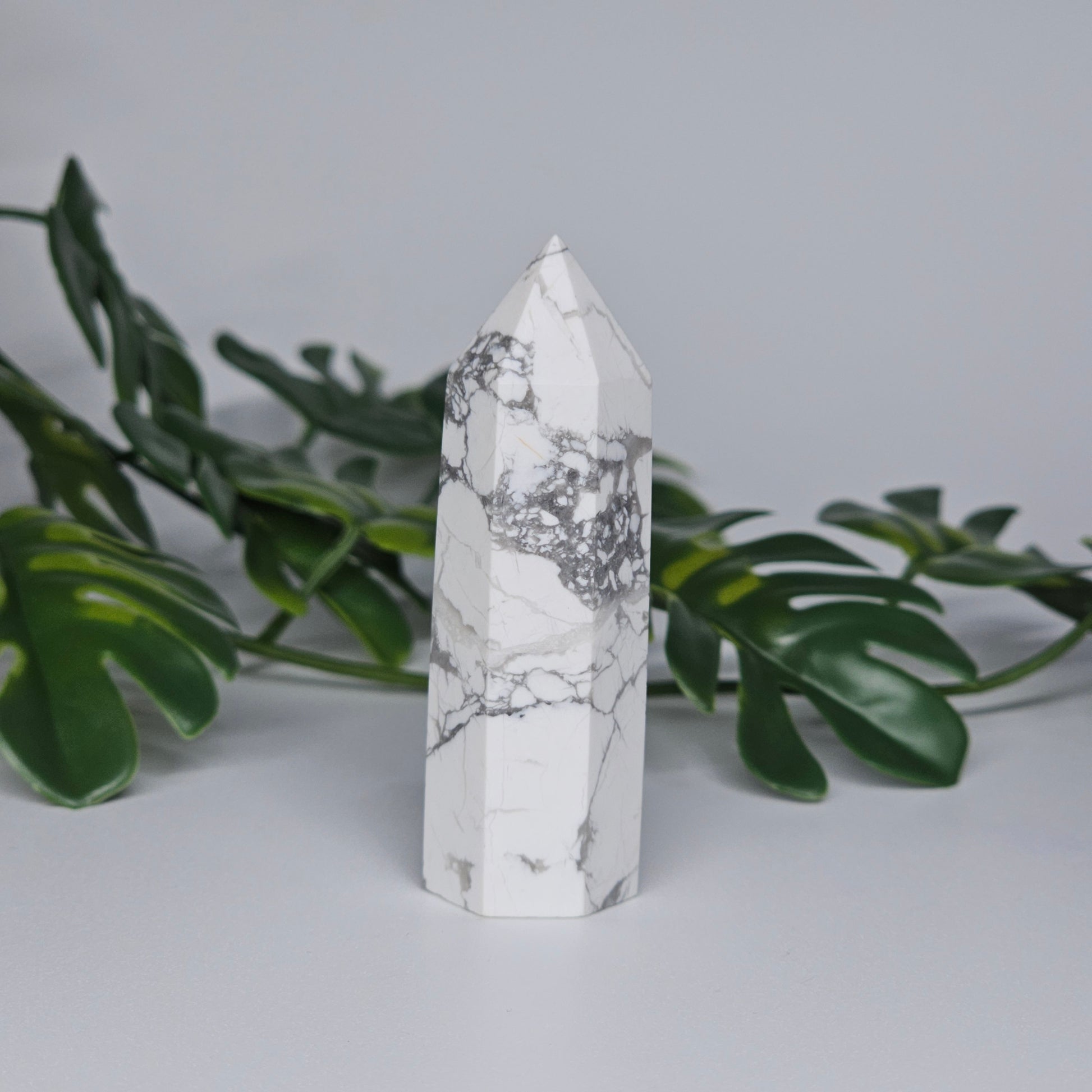 Side view of Howlite tower showing white stone and grey veining.