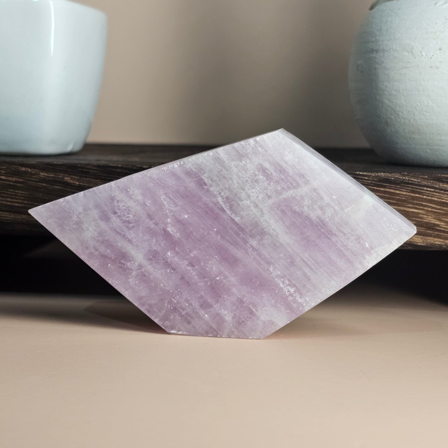 Kunzite slab photographed standing on an alternate side, highlighting natural shape and soft pastel colouring.