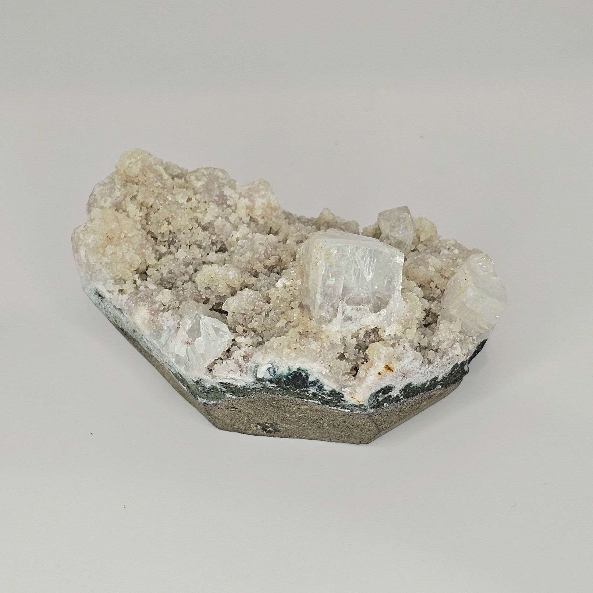Alternative angle of the Mauve Apophyllite specimen displaying its sparkling druzy surface, cubic crystal growth, and dimensional structure in studio lighting.