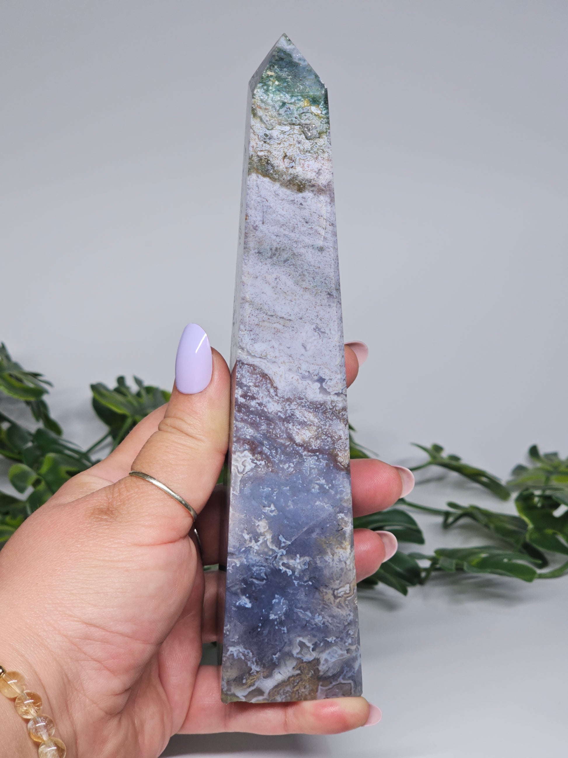 Large moss agate and blue chalcedony tower held in hand showing size and detail