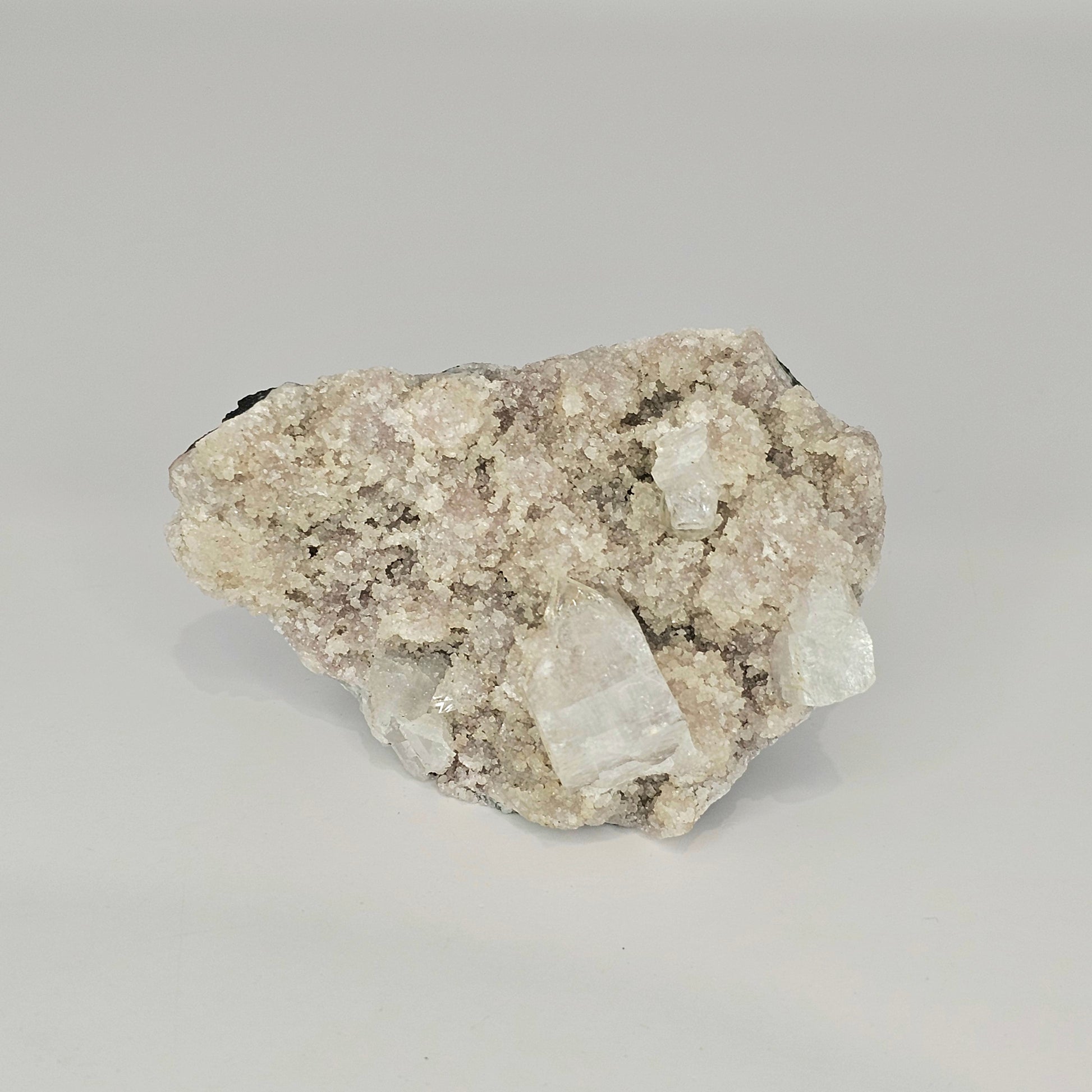 Detailed view of the natural cubic Apophyllite crystal formations with soft mauve tones and intricate mineral structure from India.