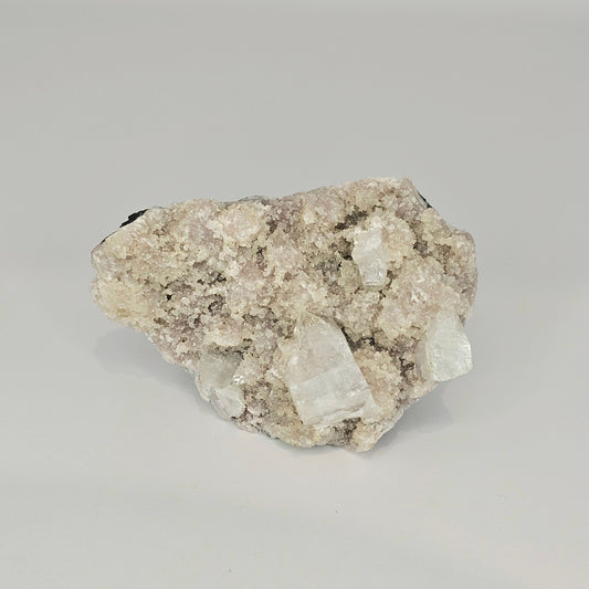 Detailed view of the natural cubic Apophyllite crystal formations with soft mauve tones and intricate mineral structure from India.