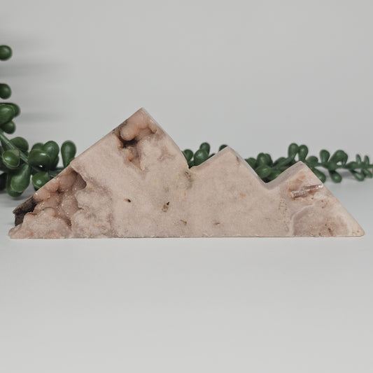 A 130g mauvy pastel Pink Amethyst mountain carving with shimmering sugar druzy on the first peak and bottom left edge.