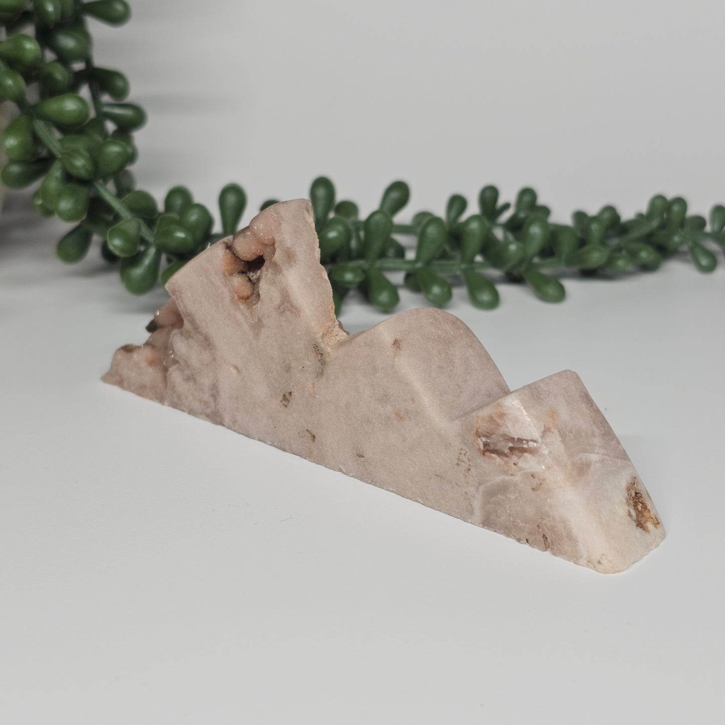 An angled side view of the mountain carving showing the polished crystal