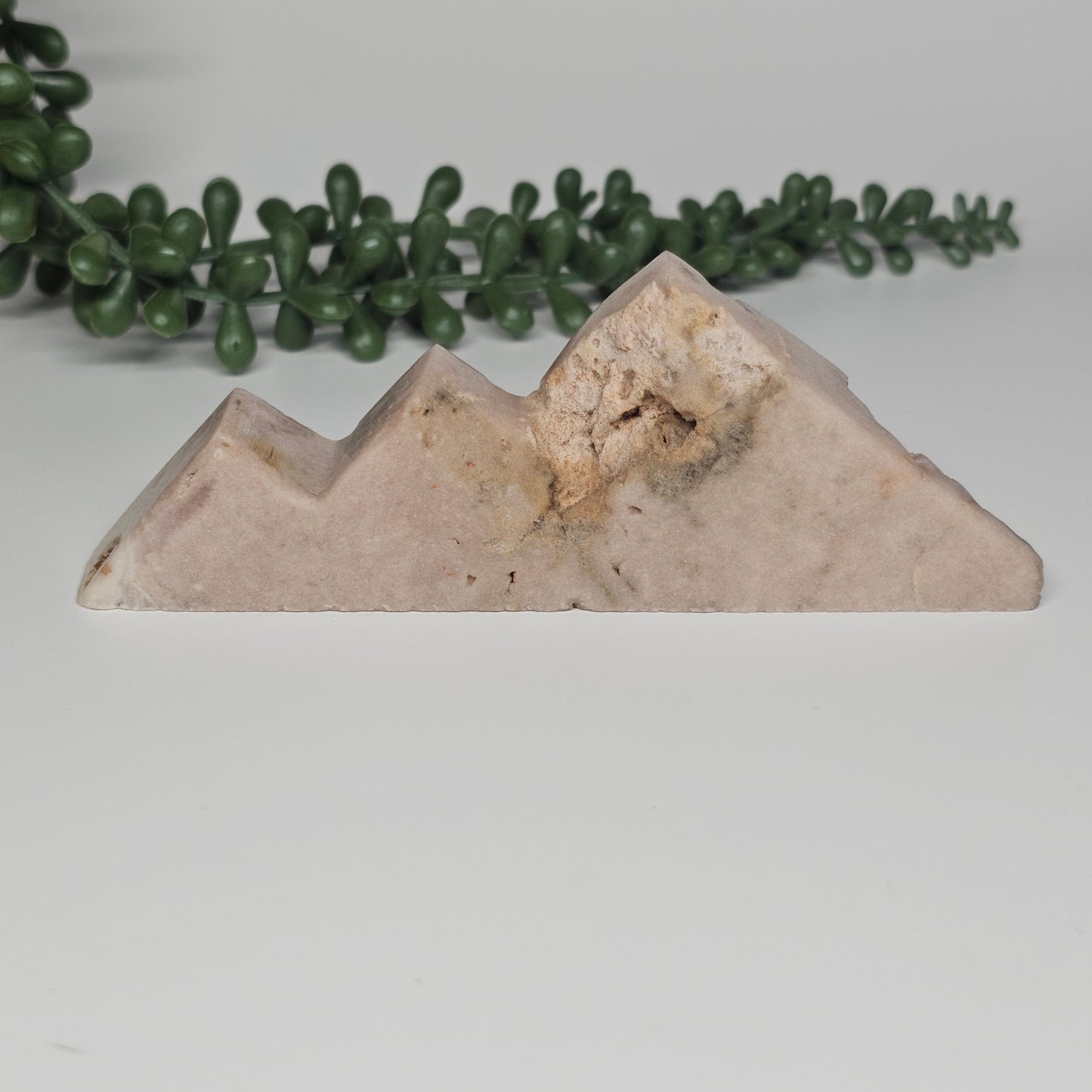 The reverse side of the crystal showcasing the natural, unpolished raw form of the Pink Amethyst and its organic texture.