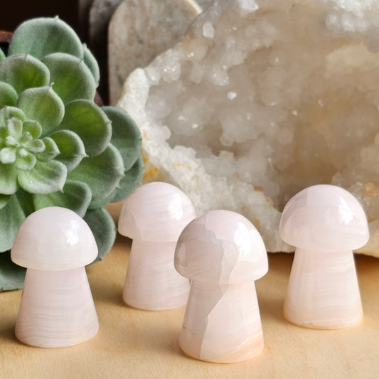 Group of Pink Mangano Calcite mushroom carvings with soft pink tones and smooth polished surfaces.