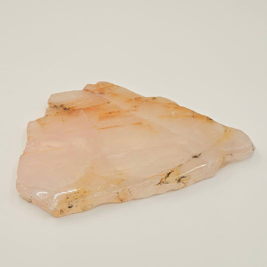 Polished translucent Dendritic Rose Quartz slab displayed flat, highlighting natural iron inclusions, soft pink colouring, and internal rainbows.