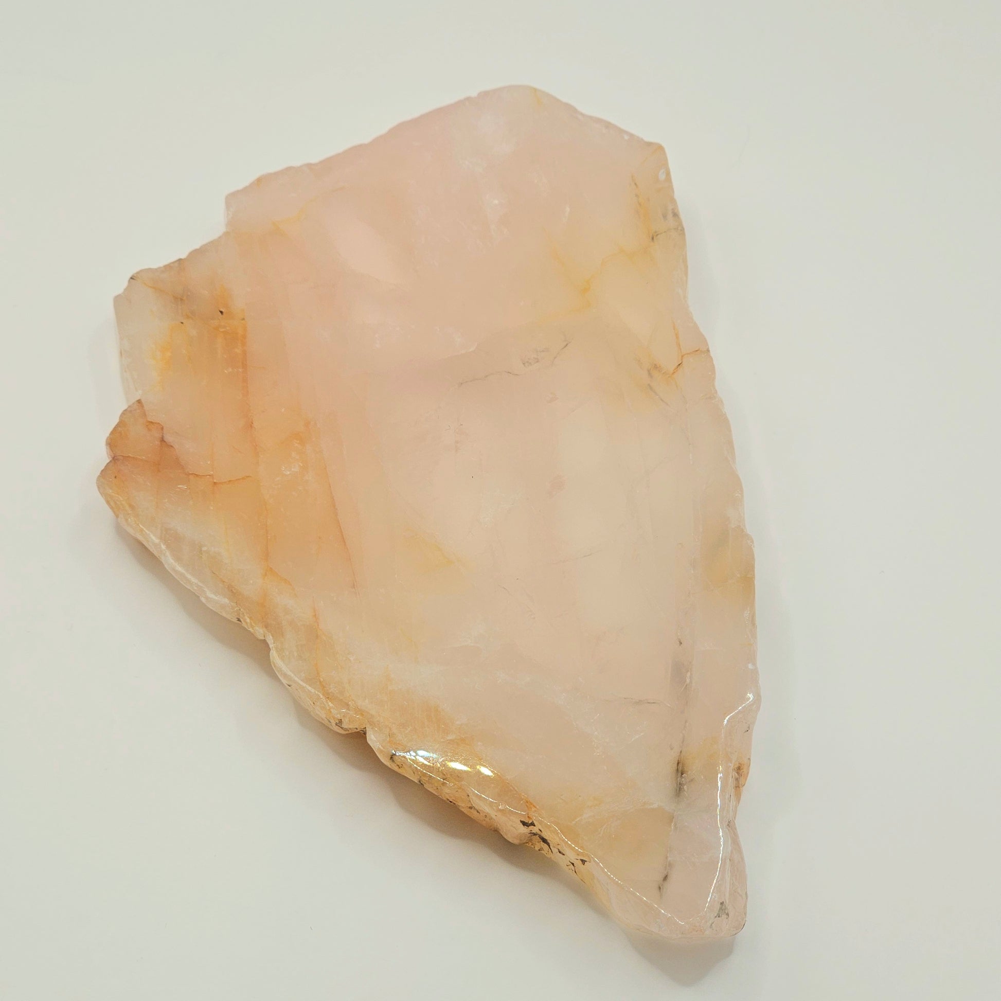 Polished translucent Dendritic Rose Quartz slab displayed flat, highlighting natural iron inclusions, soft pink colouring, and internal rainbows.