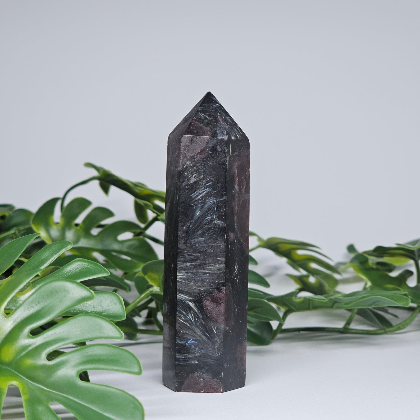 Polished Garnet and Arfvedsonite tower crystal showing natural grounding energy stone pattern