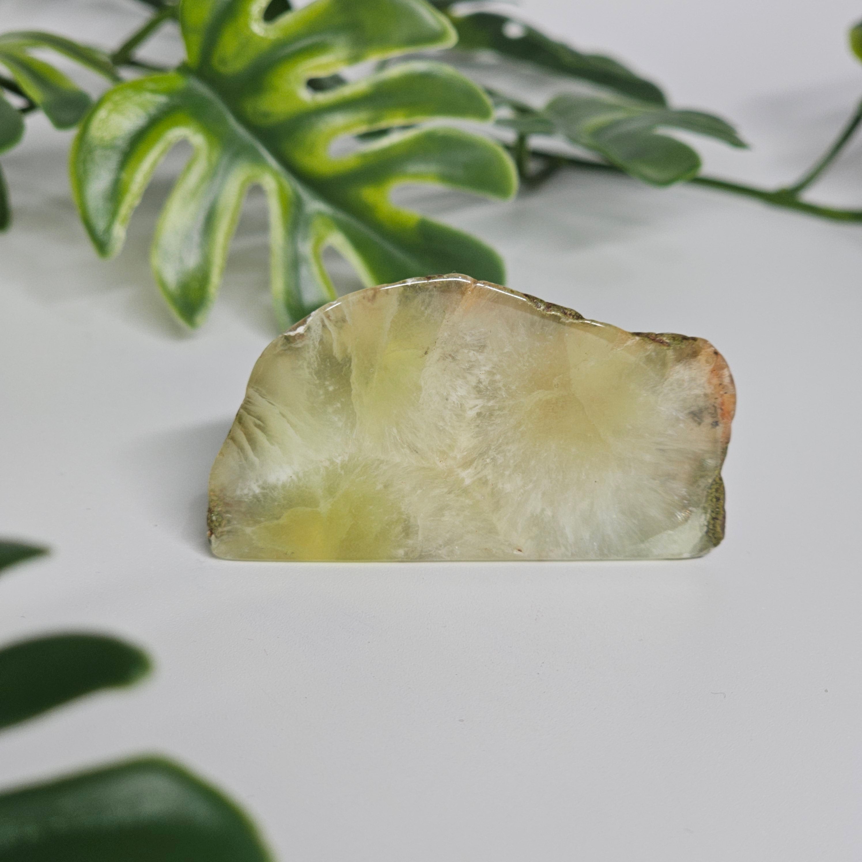 Polished Prehnite slab featuring soft green colouring, natural inclusions, and a smooth finish. Beautiful crystal display piece available in Australia.