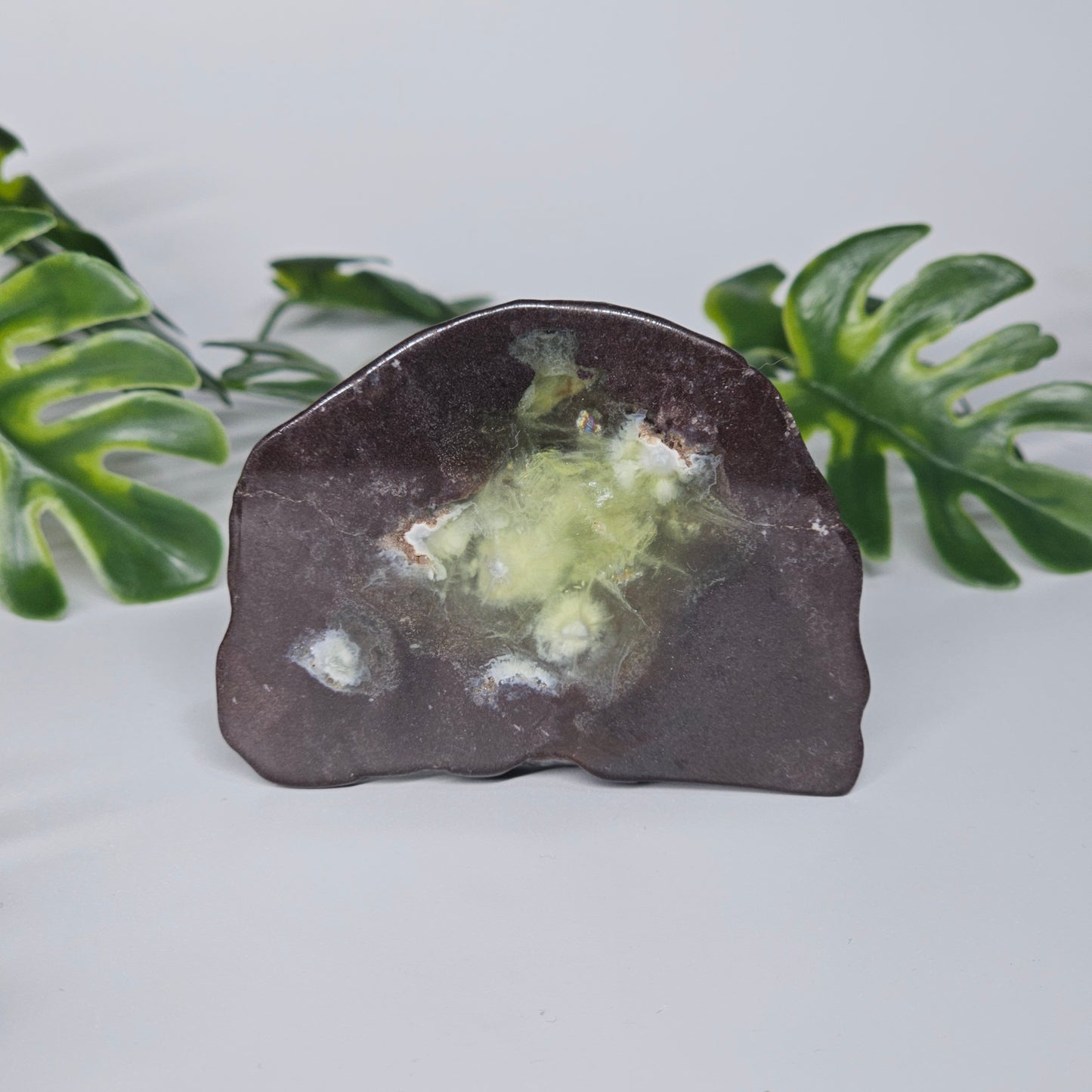 Polished Prehnite slab featuring soft green colouring, natural inclusions, and a smooth finish. Beautiful crystal display piece available in Australia.