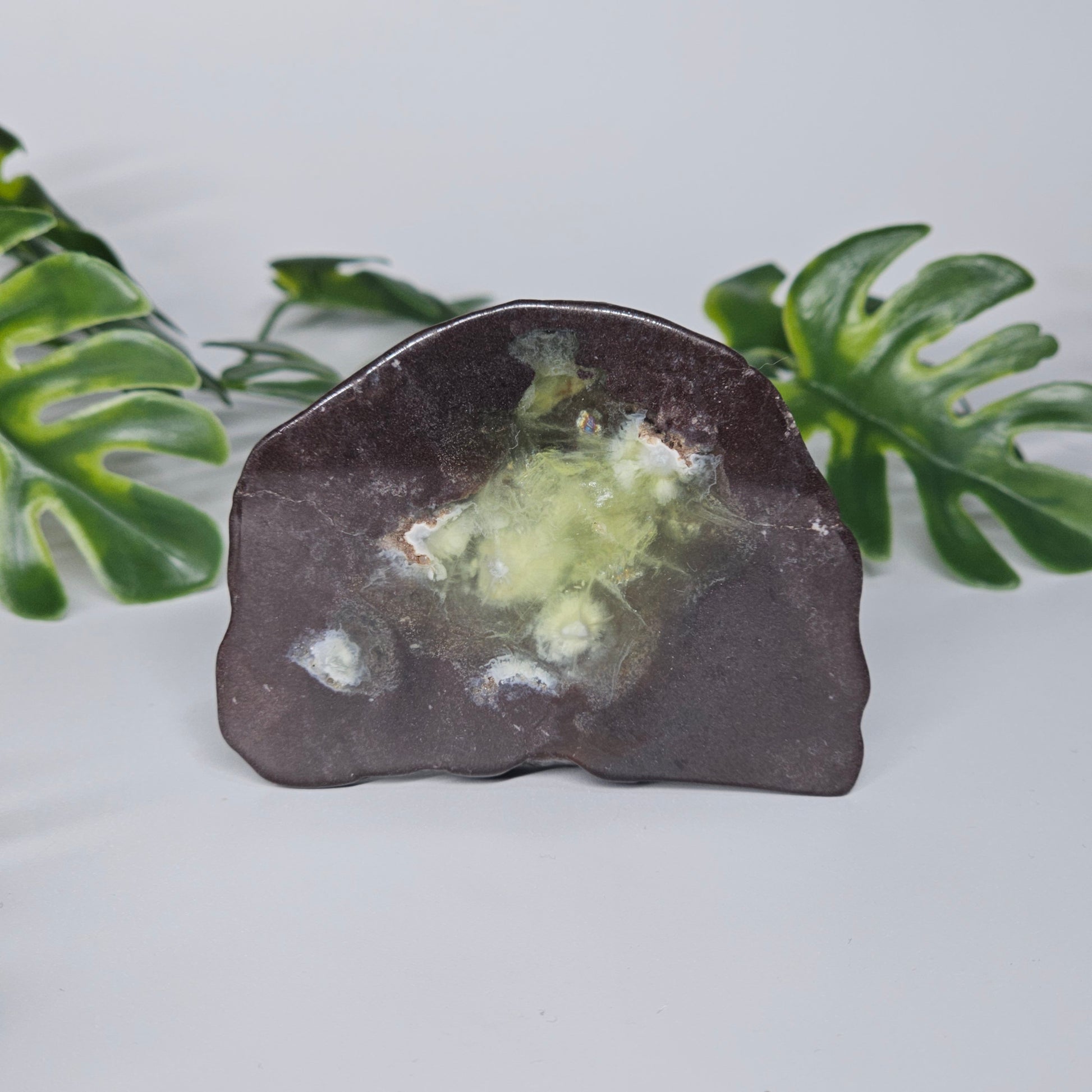 Polished Prehnite slab featuring soft green colouring, natural inclusions, and a smooth finish. Beautiful crystal display piece available in Australia.