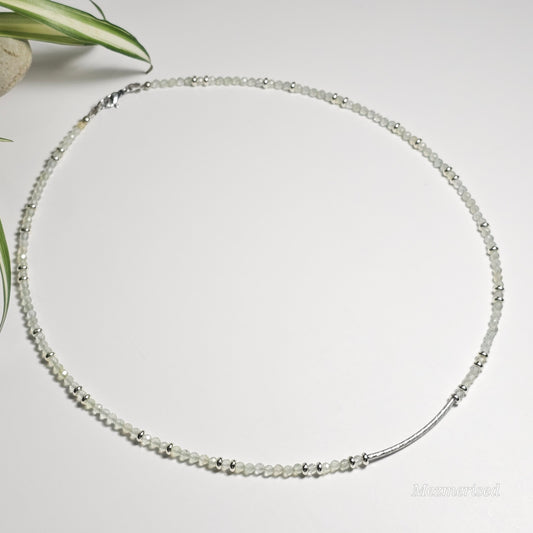Description:
Full view of Prehnite beaded necklace showing complete design with faceted beads, brass accents, and curved bar detail.