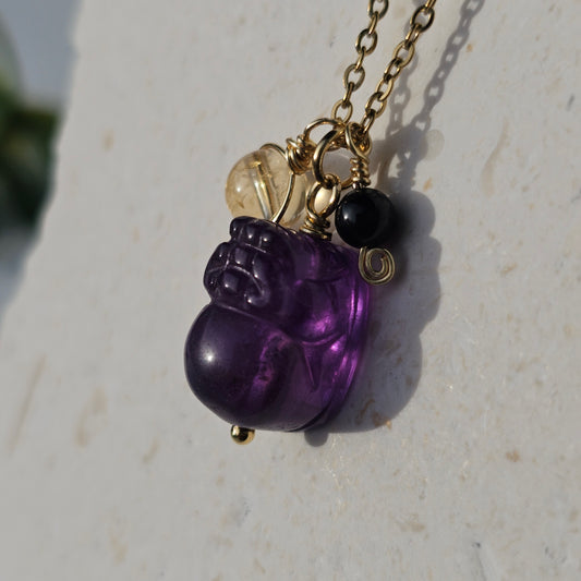 Protected Prosperity Necklace displayed hanging to show full length design featuring Amethyst Pixiu Citrine and Black Tourmaline on a gold plated chain