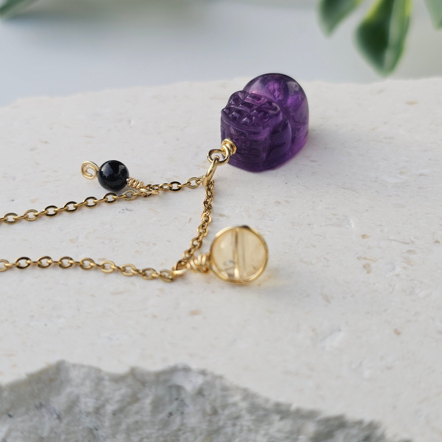 Upright view of Amethyst Pixiu on the Protected Prosperity Necklace with Citrine and Black Tourmaline beads splayed to highlight design and symmetry