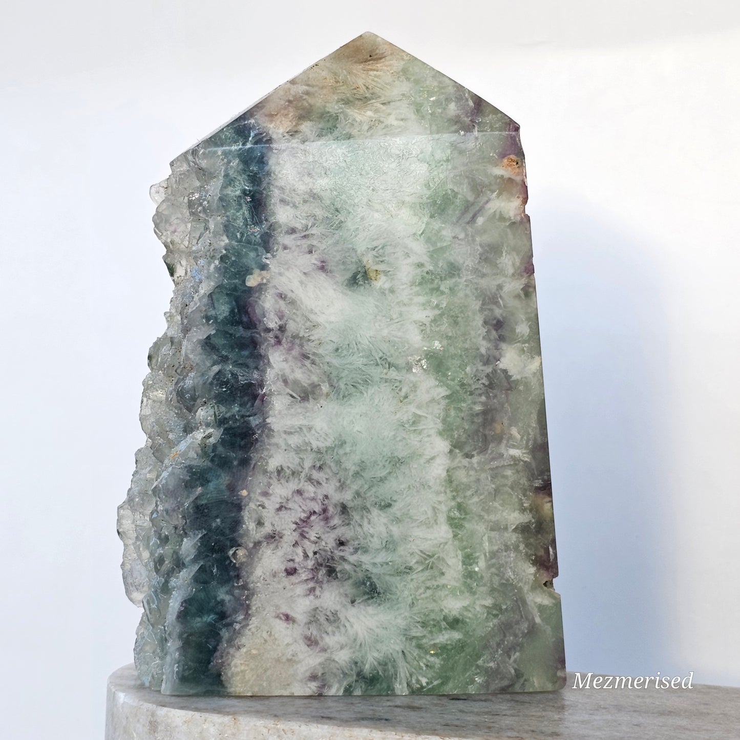 Rainbow Feather Fluorite tower with green, blue and purple tones, featuring natural feather patterns, internal rainbows and a sparkling druzy edge.