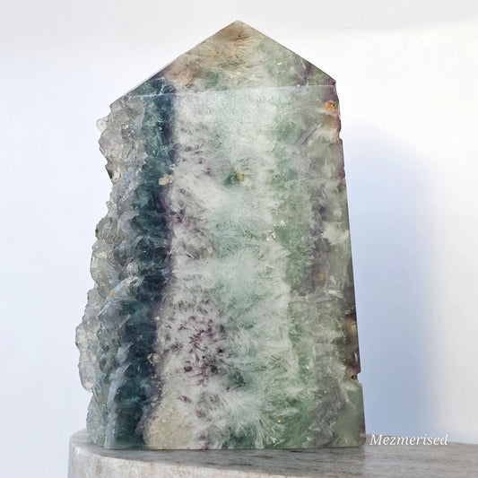 Rainbow Feather Fluorite tower with green, blue and purple tones, featuring natural feather patterns, internal rainbows and a sparkling druzy edge.