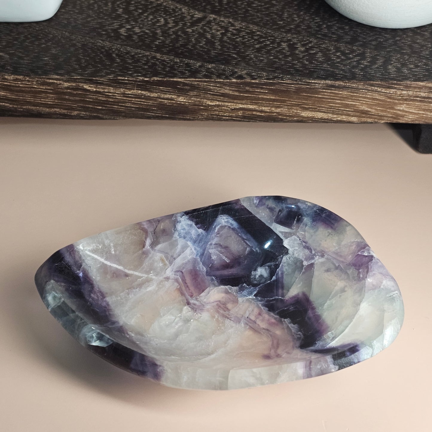 Close-up detail of the Fluorite dish highlighting its internal colour zoning and subtle rainbow inclusions within the crystal structure.