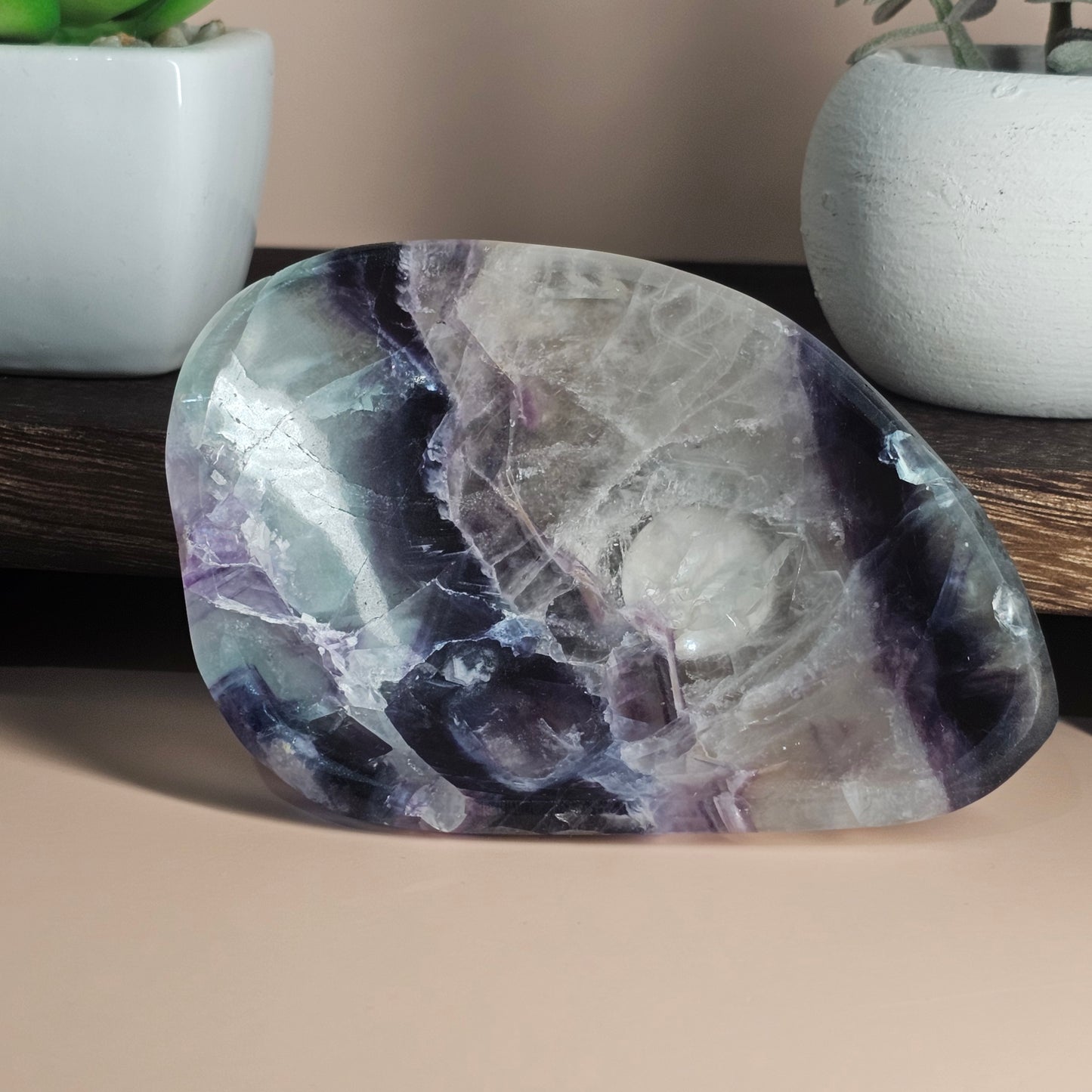 Propped display view of the Rainbow Fluorite dish highlighting its full shape, polished finish, and natural multi-colour zoning under balanced lighting.