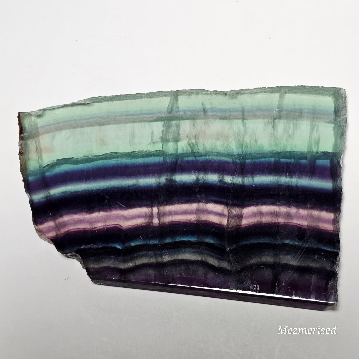 Large Fluorite slab piece laid flat showing surface and colour.